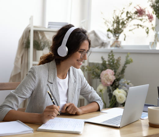 Woman sitting infront Notebook beeing in a webcast (Lets Talk About Head Banner Web)