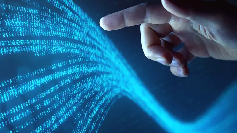 Hand Touches Flowing Stream Of Binary Code