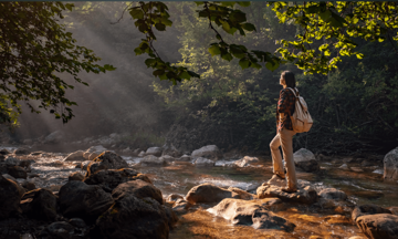 Woman Standing On A Rock In A River