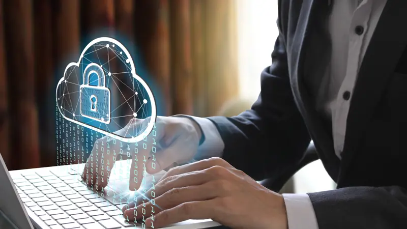 Man At Laptop Looking At Digital Cloud Lock Symbol