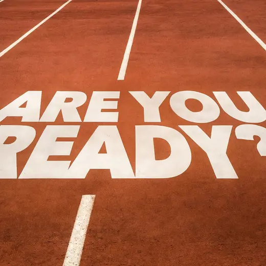 ARE YOU READY Painted In Bold White Letters On A Red Running Track With Lane Lines