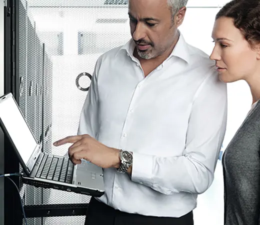 Man Woman In Data Center With Laptop