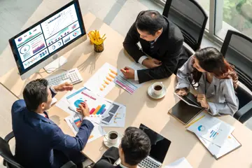 Group Of People Sitting Around A Table Aerial View