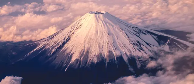 Snow Capped Mountain Peak During Sunrise