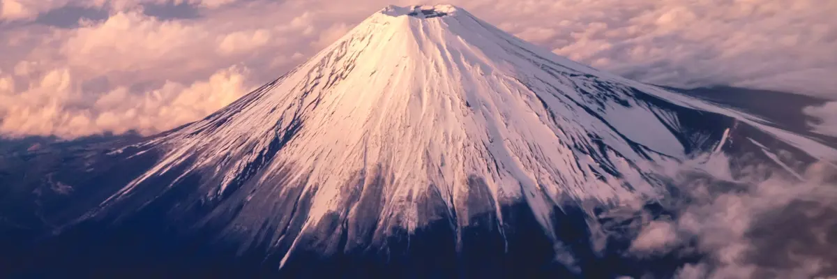 Snow Capped Mountain Peak During Sunrise