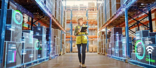 Woman Uses Digital Tablet To Work On A Logistics Warehouse