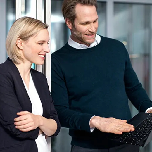 Man Woman Disussion In Front Of Laptop