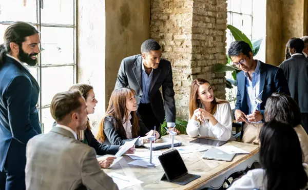 Group Of People Sitting Around A Table