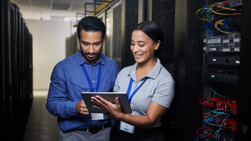 Woman Man Collaborate On Tablet In Data Center