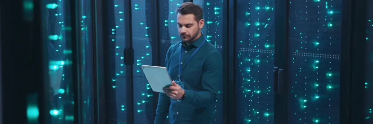 Man With Tablet in a dark data center