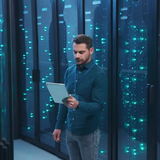 Man With Tablet in a dark data center