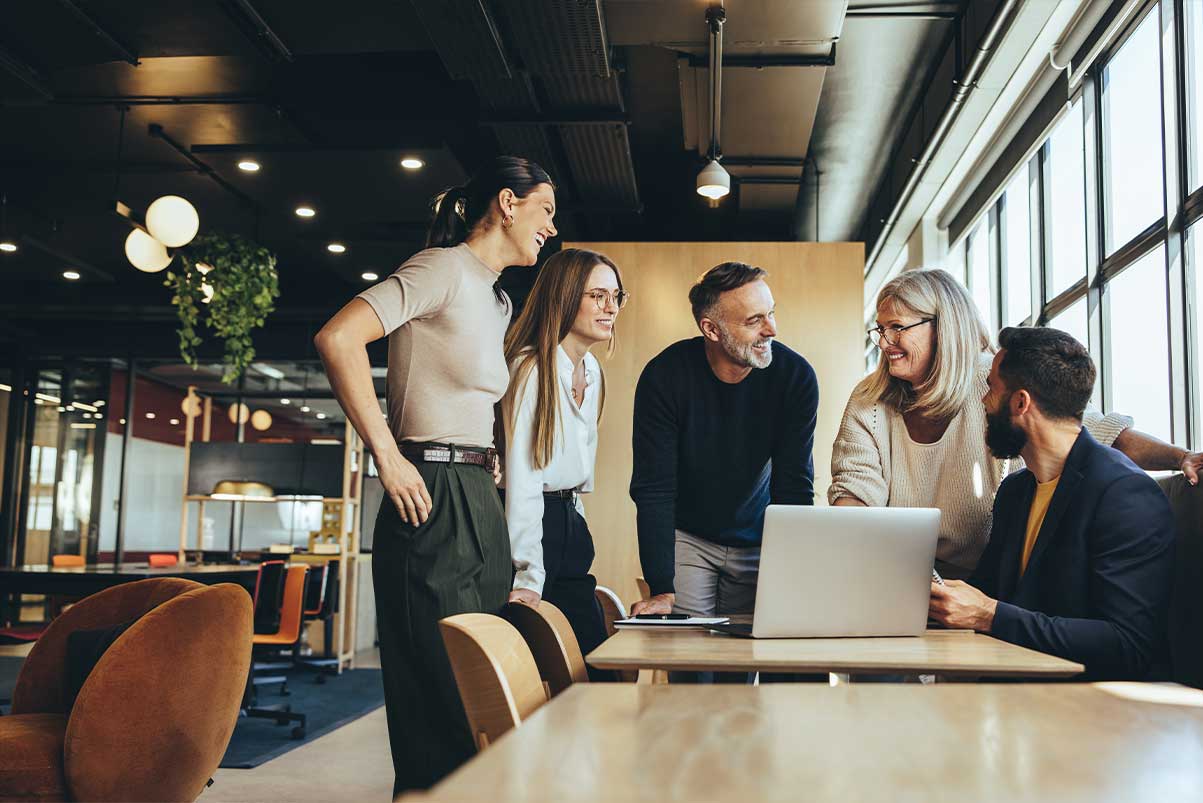 Smiling Businesspeople Having A Discussion In A Modern Workspace RS82252