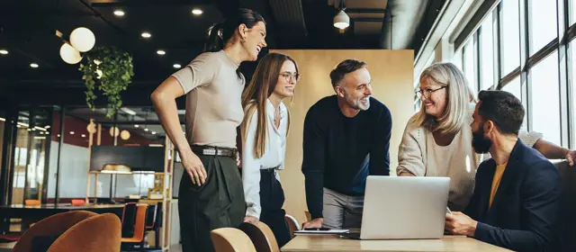 Smiling Businesspeople Having A Discussion In A Modern Workspace RS82252