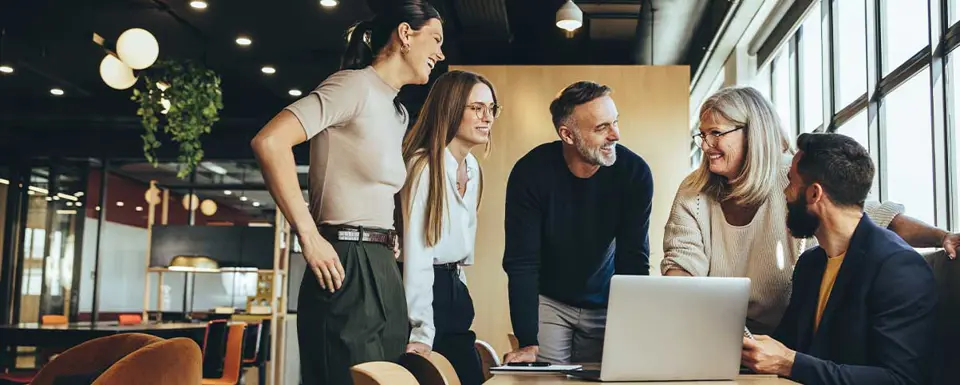 Smiling Businesspeople Having A Discussion In A Modern Workspace RS82252