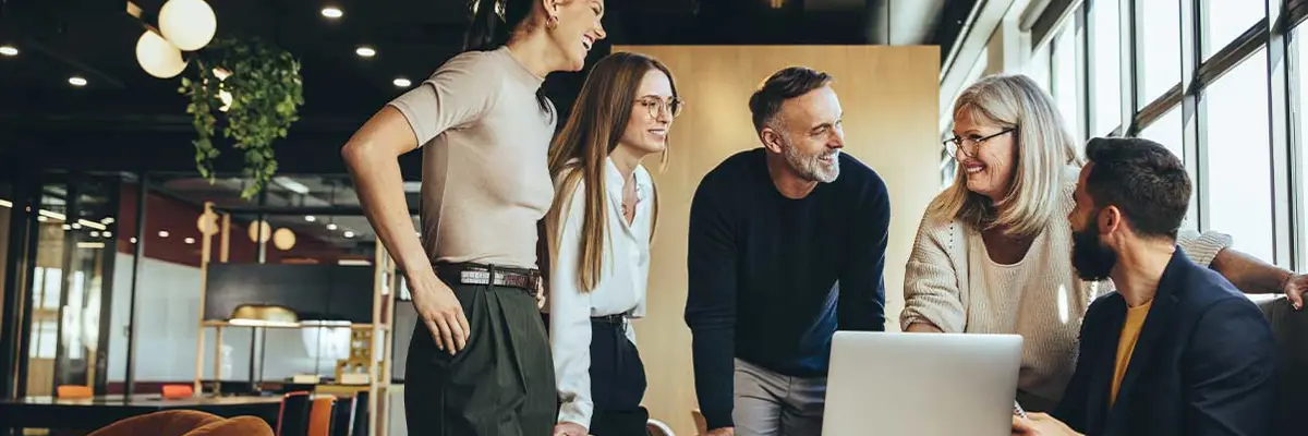 Smiling Businesspeople Having A Discussion In A Modern Workspace RS82252