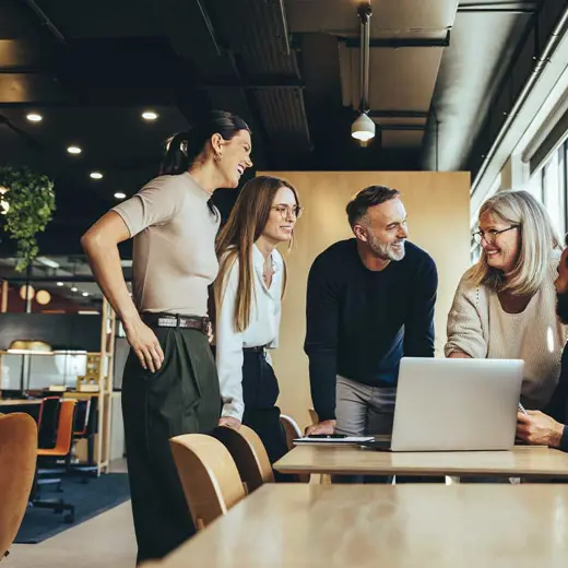 Smiling Businesspeople Having A Discussion In A Modern Workspace RS82252