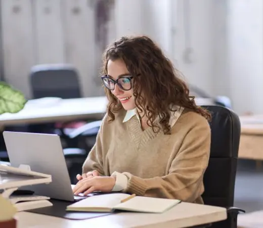Woman Working On A Laptop In An Office