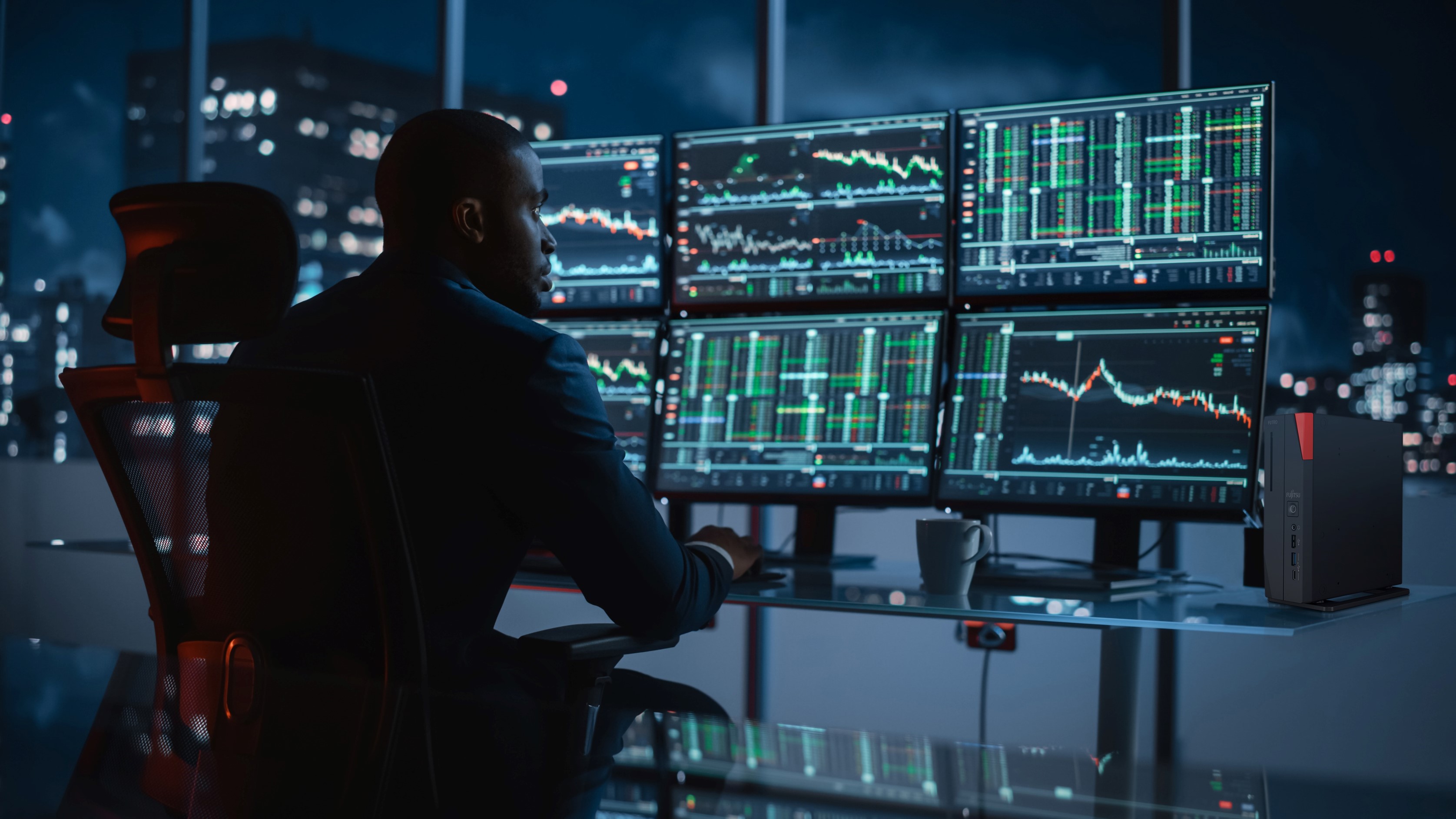 Man Focused On Multiple Monitors