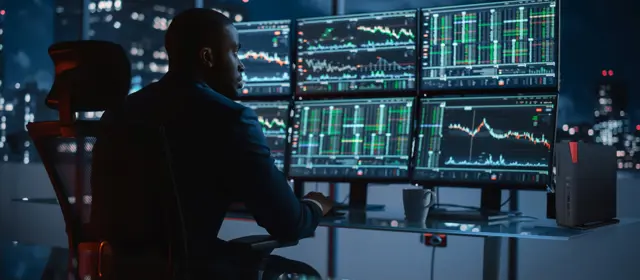 Man Focused On Multiple Monitors