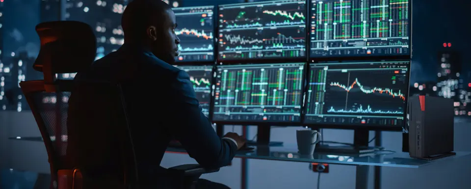 Man Focused On Multiple Monitors
