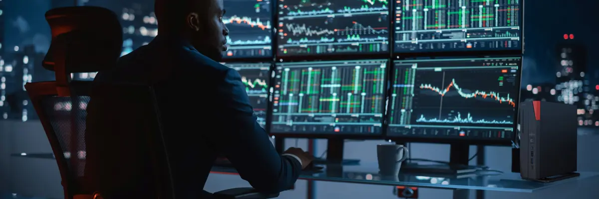 Man Focused On Multiple Monitors