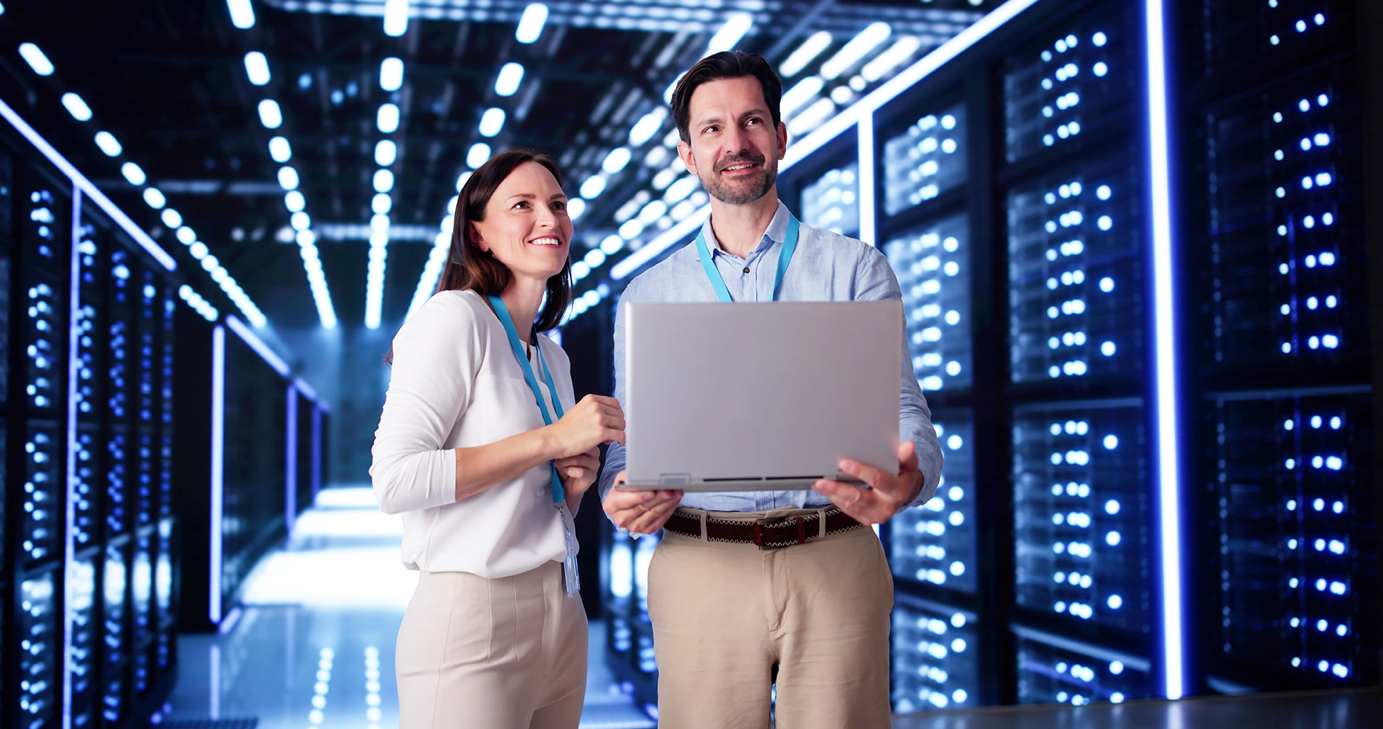 Man and Woman in Data Center holding Laptop