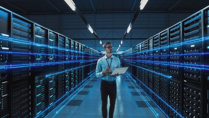 Man Data Center Holding Laptop