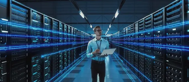 Man Data Center Holding Laptop