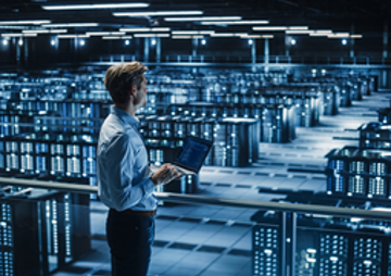 Man lookin at Data Center from a 2nd floor