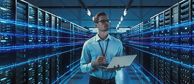 Man In A Serverrom With Notebook