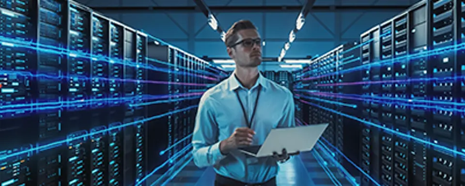 Man In A Serverrom With Notebook