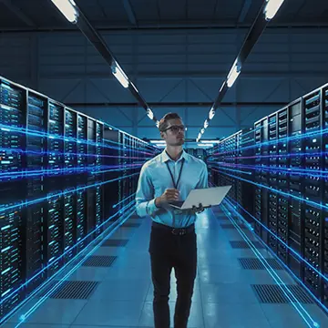 Man In A Serverrom With Notebook