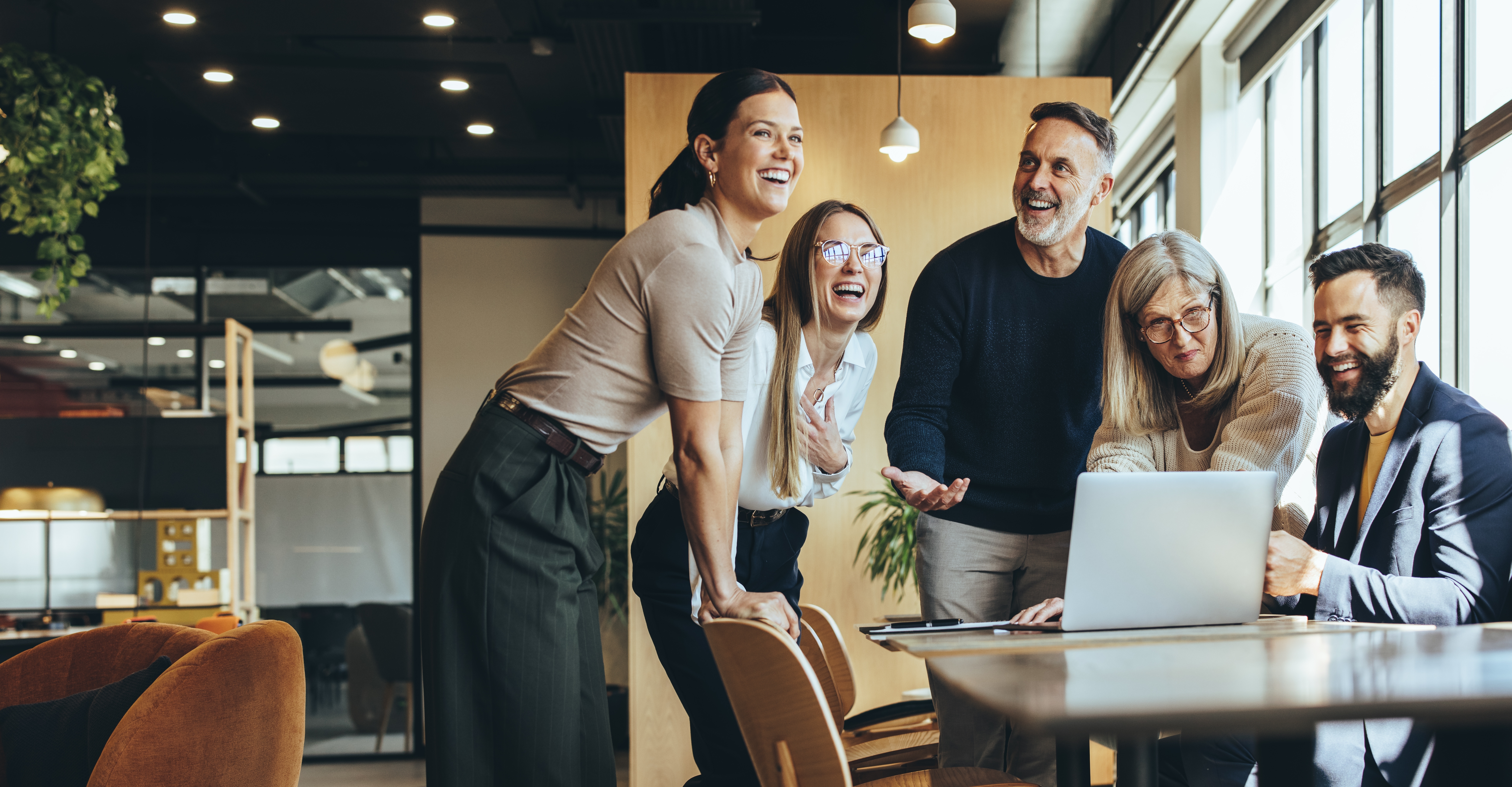 Group Of People In Office Around Laptop